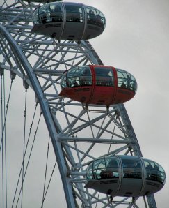 Capsules on the London Eye, one red, on London's South Bank...